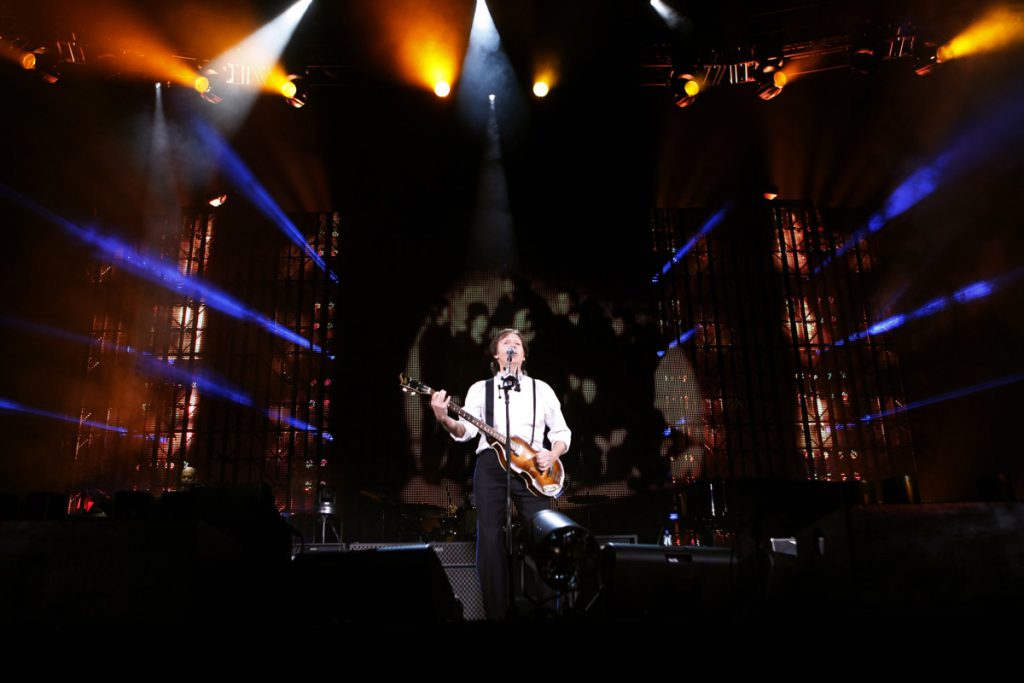 Paul on stage with the cover of 'Band on the Run' on the screen behind him, Minute Maid Park, Houston, 14th November 2012