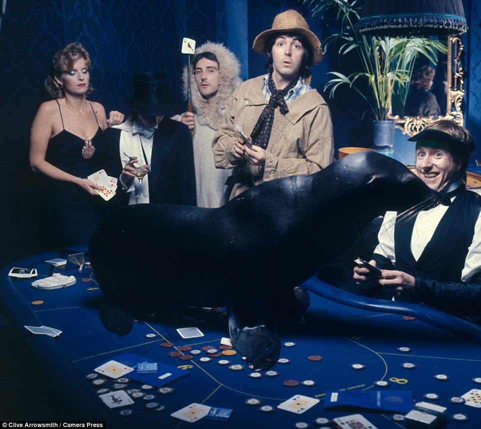 Promo shot for Junior's Farm single release. Wings pose for a casino-inspired photo in 1974 (pictured Linda McCartney, Denny Laine, Sir Paul McCartney: Jimmy McCulloch and Joe English). Arrowsmith said of the images: 'They really capture the seminal moments of the shoot... The fun we were all having, plus Paul and Linda's closeness, it's the naturalness of the pictures that is the key to their success'