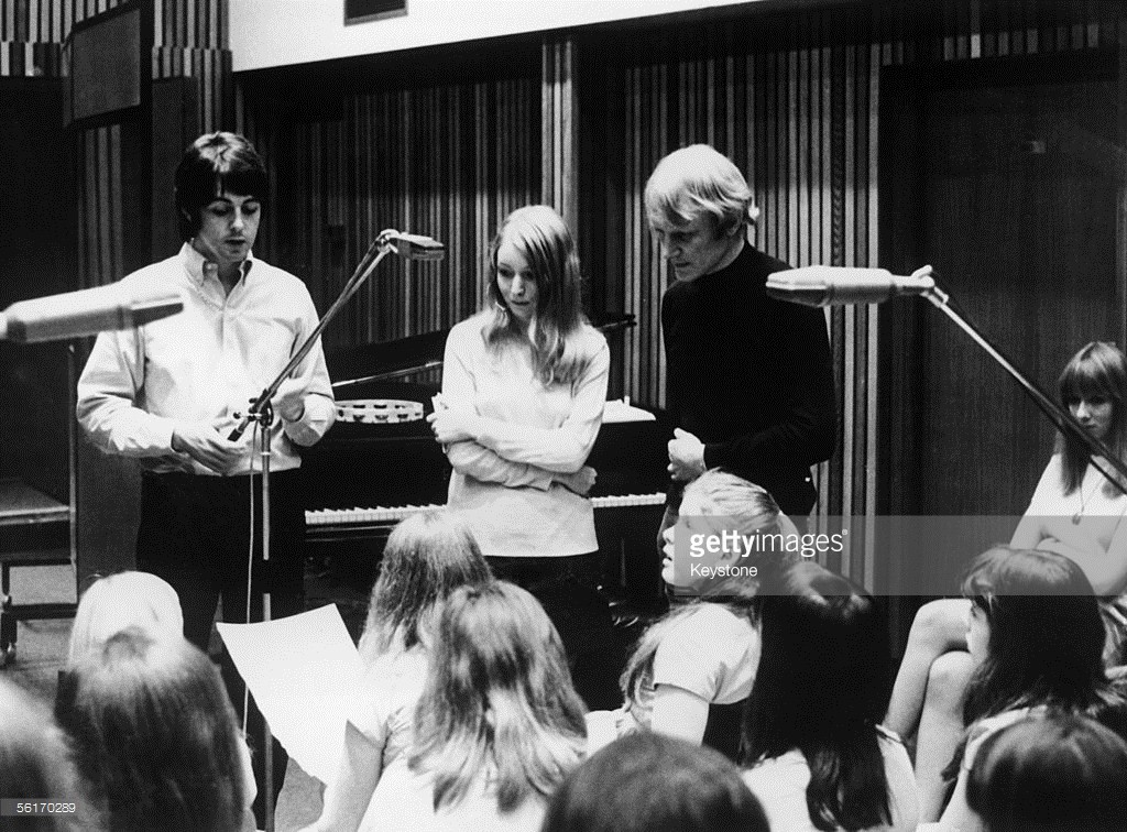 From left to right, Paul McCartney, Mary Hopkin and arranger Richard Newson enlist the aid of the Aida Foster Children's Choir to record Hopkin's song 'Those Were the Days' for the Apple label, 26th July 1968.