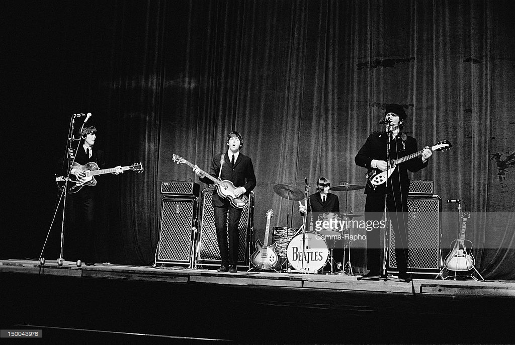 American pop singer Tony Bennett presents an award to The Beatles at the New Musical Express Poll Winners' Concert at Wembley, London. Credits: Express Newspapers