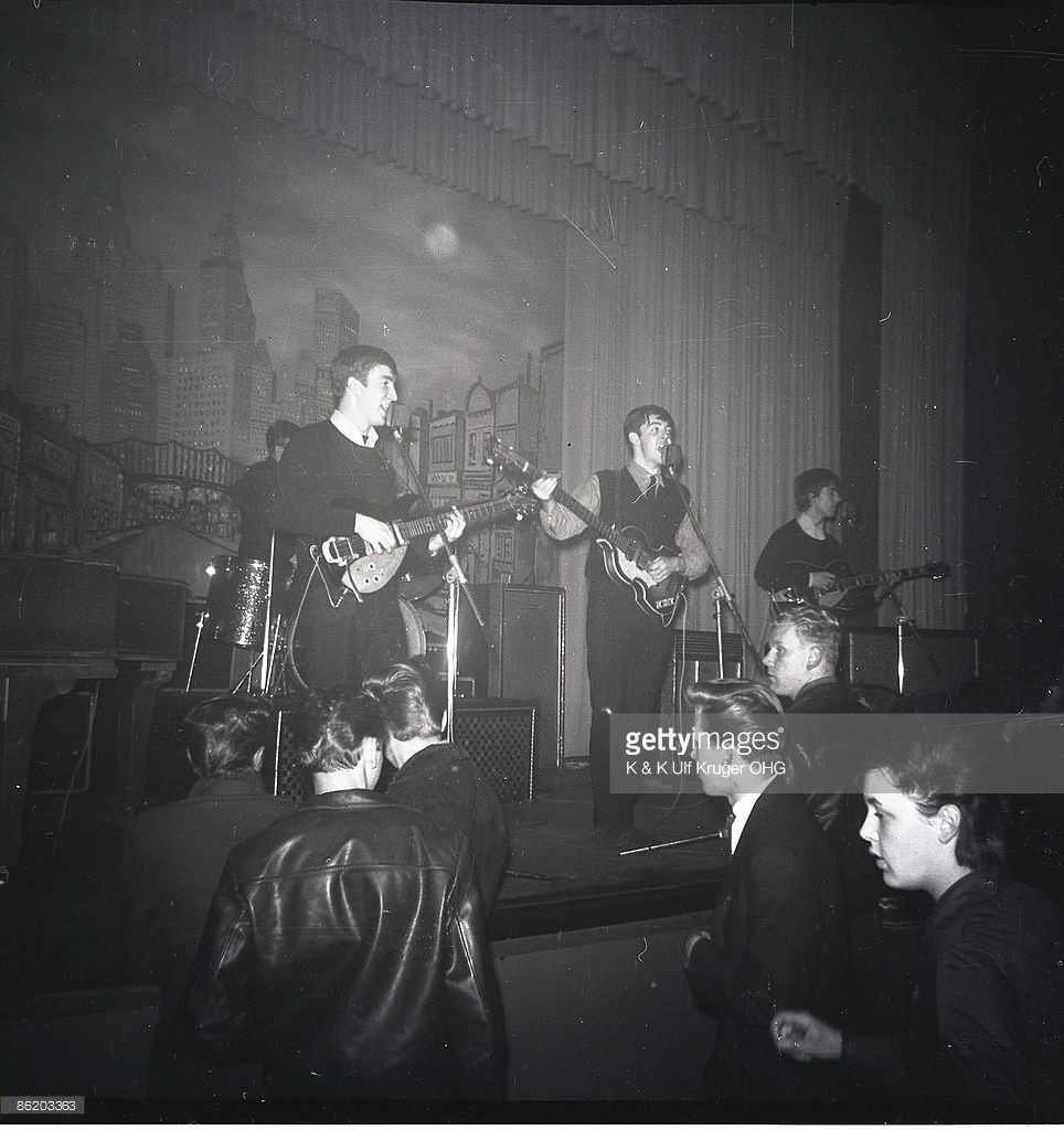 John Lennon, Paul McCartney and George Harrison of The Beatles perform live onstage circa December 1962, during their final residency at the Star-Club in Hamburg, Germany. - Photo: Danny Wall - Credits : K & K Ulf Kruger OHG