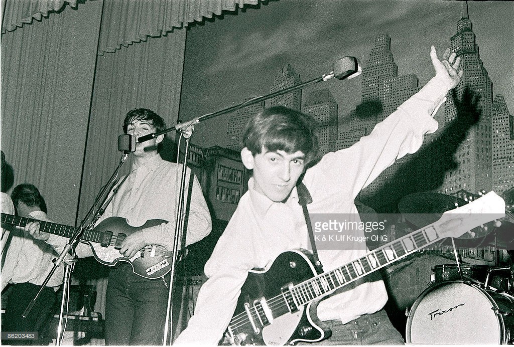 Photo of (L-R) singer-bassist Paul McCartney and guitarist George Harrison of The Beatles, live onstage circa May 1962 at the Star-Club in Hamburg, Germany - Credits : K & K Ulf Kruger OHG