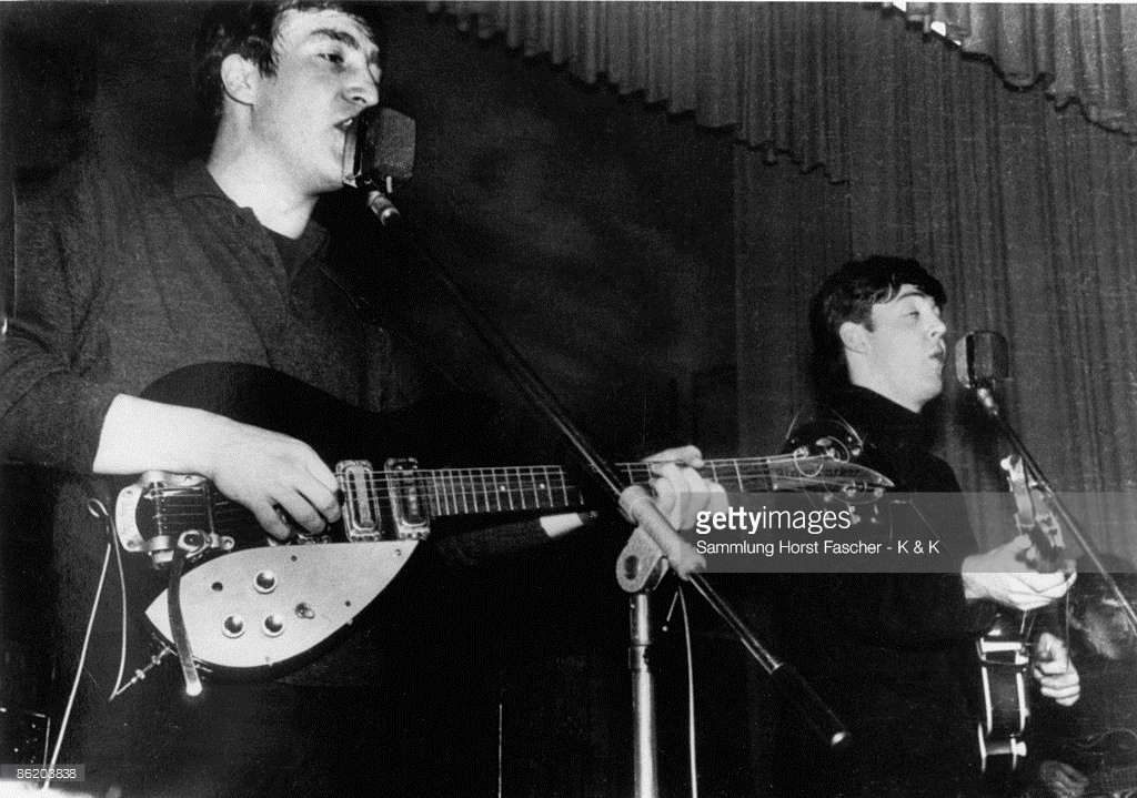 John Lennon (playing his first Rickenbacker 325 guitar, with Bigsby vibrato), Paul McCartney and George Harrison of The Beatles perform live onstage circa December 1962, during their final residency at the Star-Club in Hamburg, Germany - Credits : Sammlung Horst Fascher - K & K