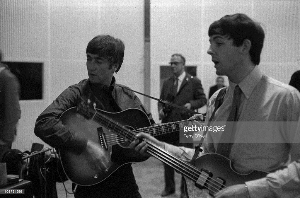 John Lennon and Paul McCartney of The Beatles in Studio 2 at Abbey Road in London recording the single 'She Loves You', 1st July 1963. Lennon plays a Gibson J160E acoustic guitar and McCartney a Hofner 500/1 violin bass.